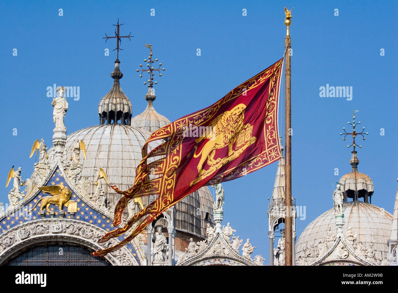 Venetian flag flying in front of the Basilica San Marco in the Piazza San Marco Venice Italy Stock Photo