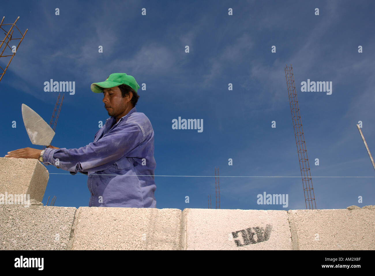 A Mexican construction worker builds houses in Cancun Mexico Stock Photo