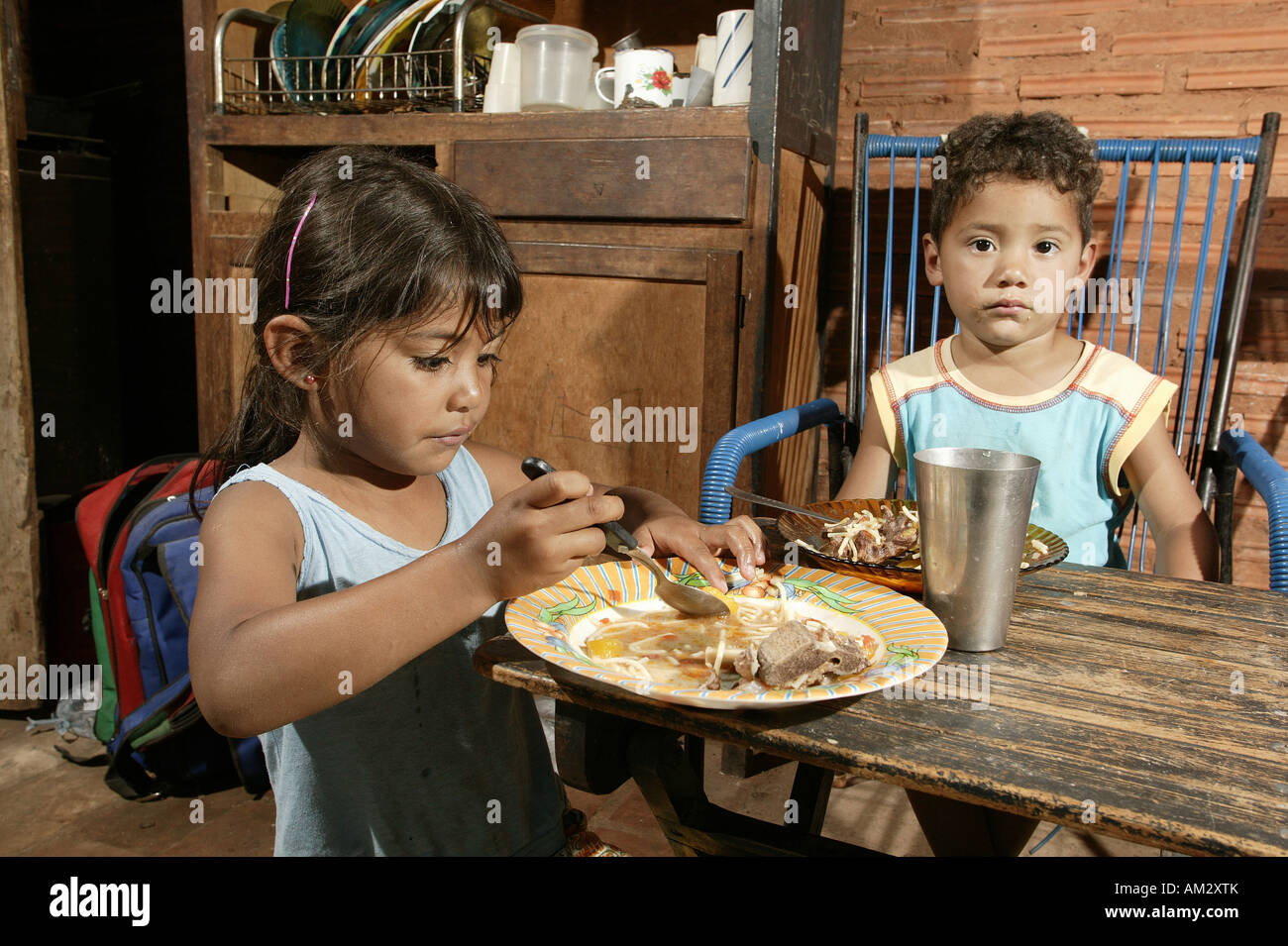 Guarani children eating in the poor area of Chacarita, Asuncion, Paraguay, South America Stock Photo