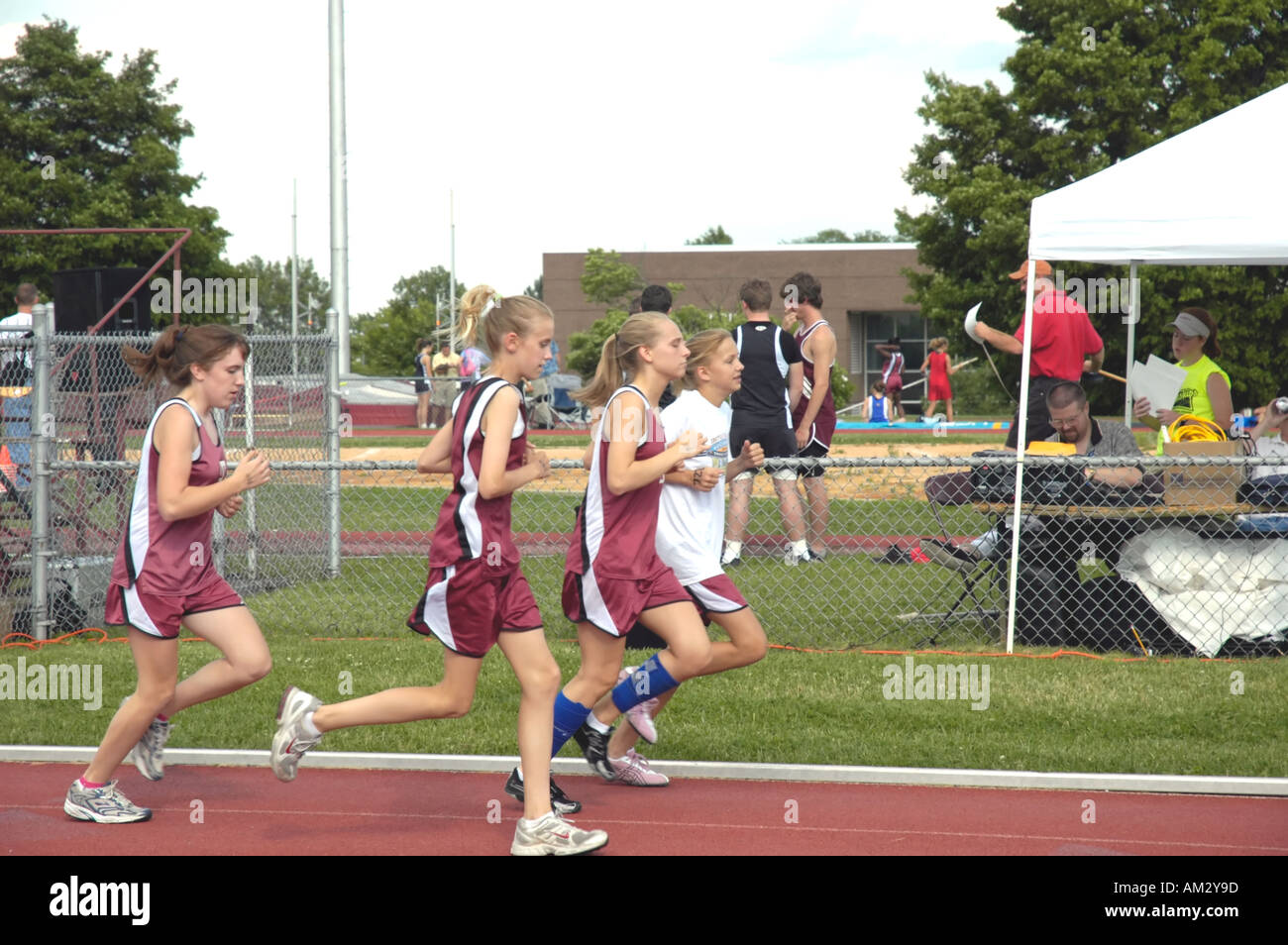 Teenage girl runners at a high school track and field district meet
