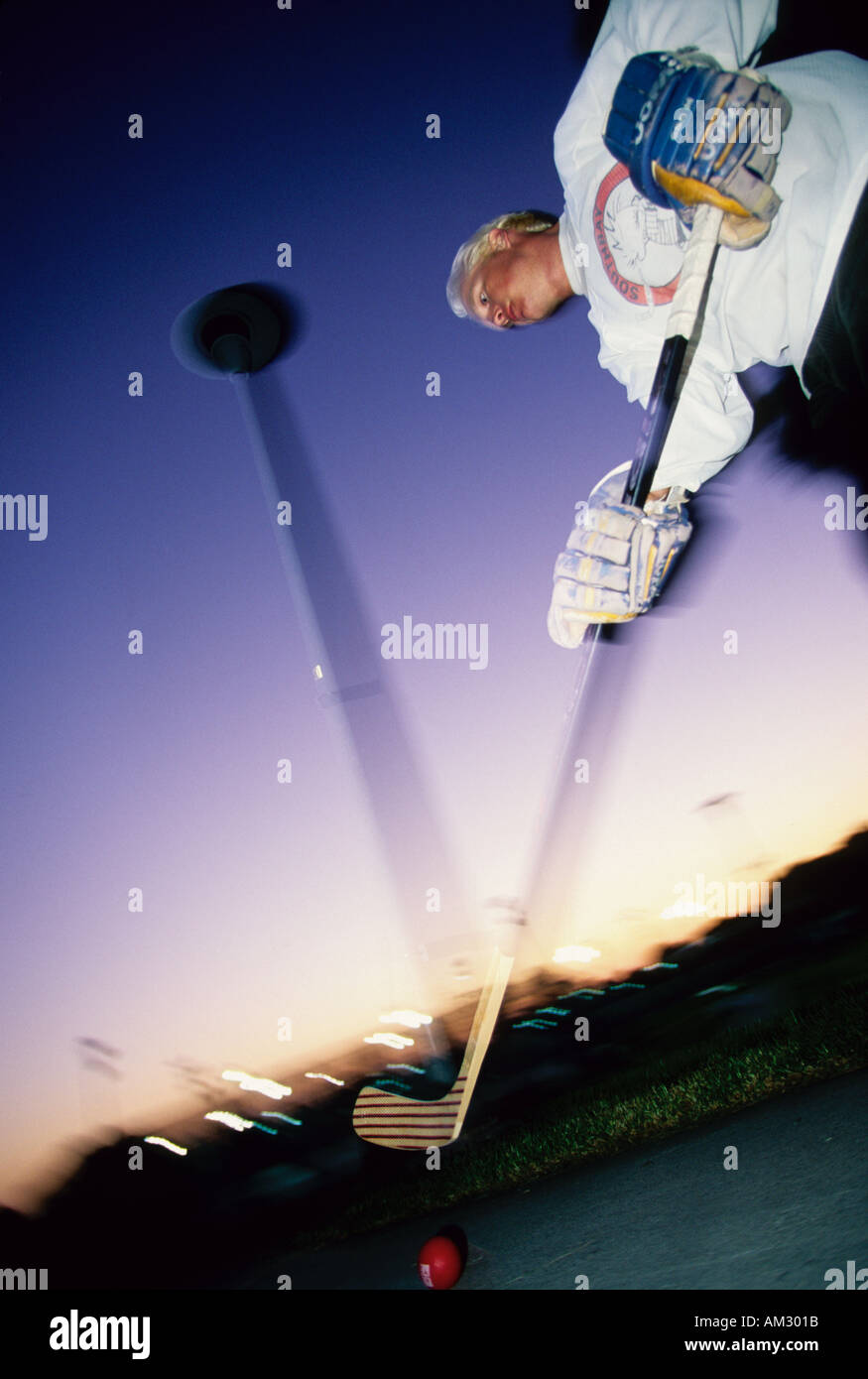 A man practicing street hockey on inline skates Stock Photo Alamy