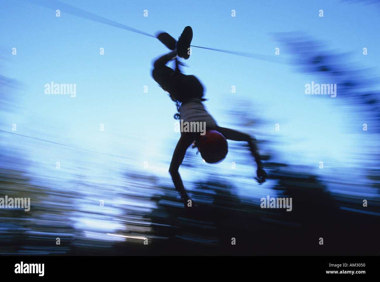 A woman on a zip line part of a ropes course Mammoth Mountain California Stock Photo