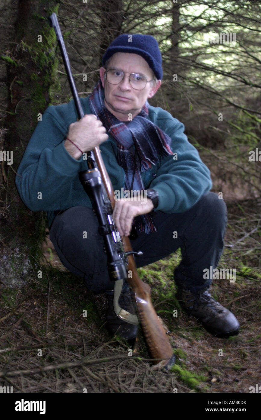 Deer Hunter with rifle in Ireland Stock Photo