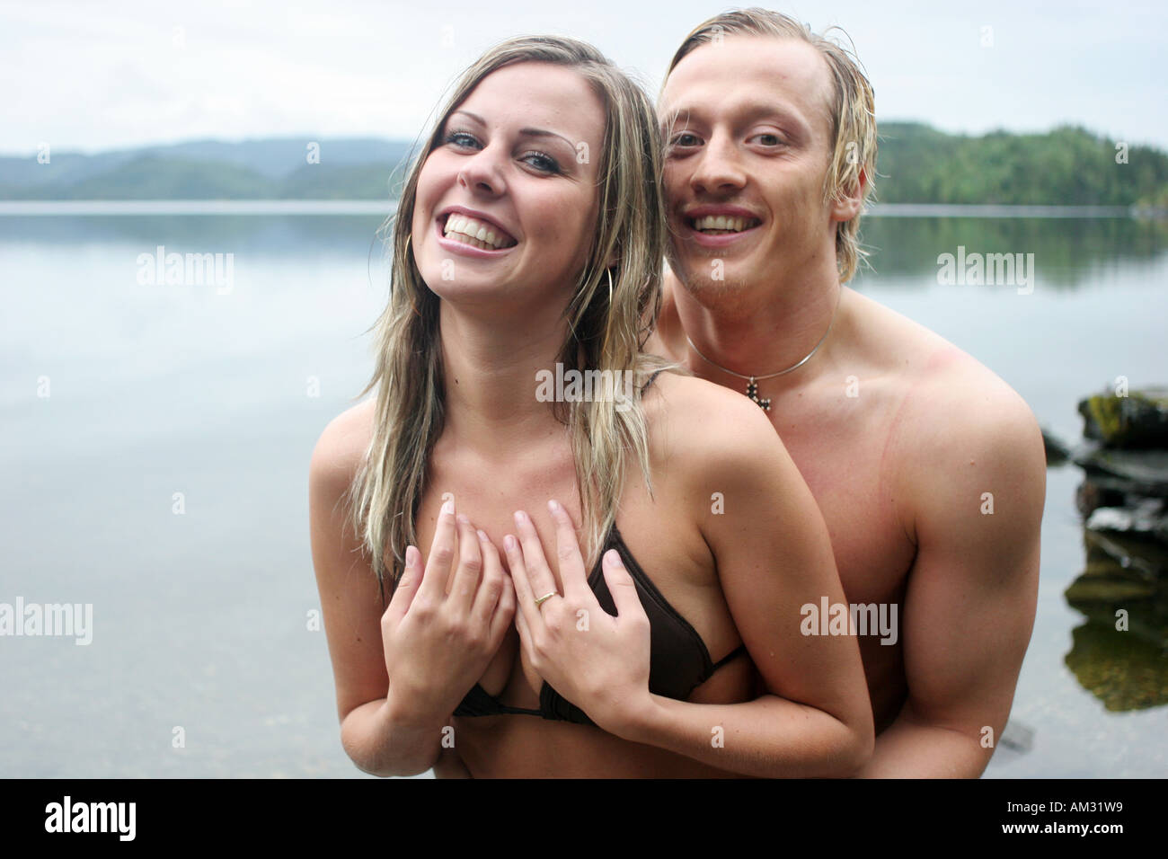 happy bikini couple on the lake Stock Photo