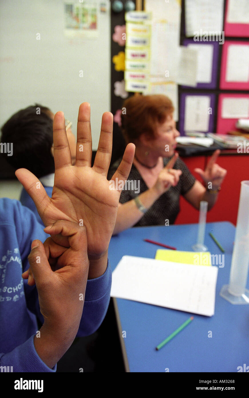 Female teacher working with deaf children in a special school Stock
