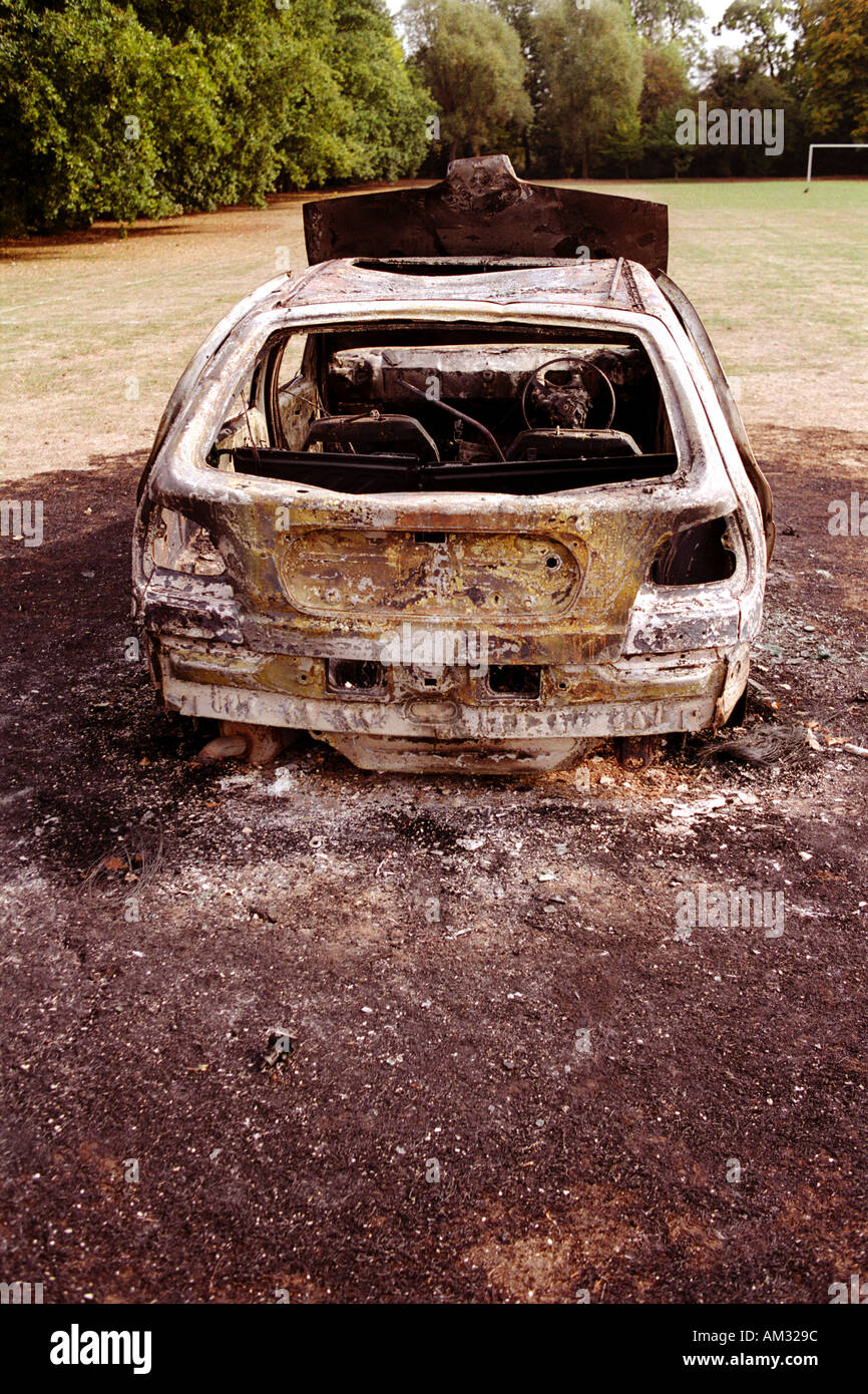 Burnt out car abandoned and left burn out in park by young joy riders