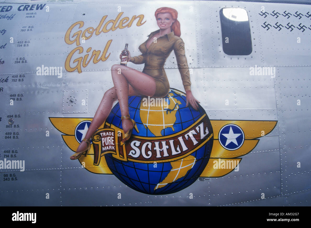 A B24 Liberator bomber is decorated with the Schlitz Golden Girl logo and swastika marks for the number of German planes downed Stock Photo