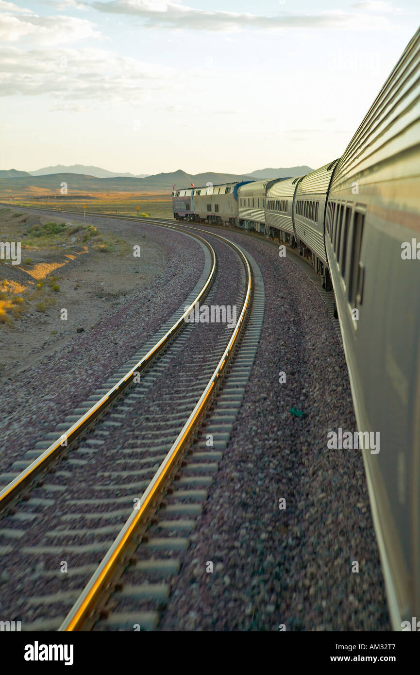 Passenger train traveling into the Arizona sunset Stock Photo Alamy