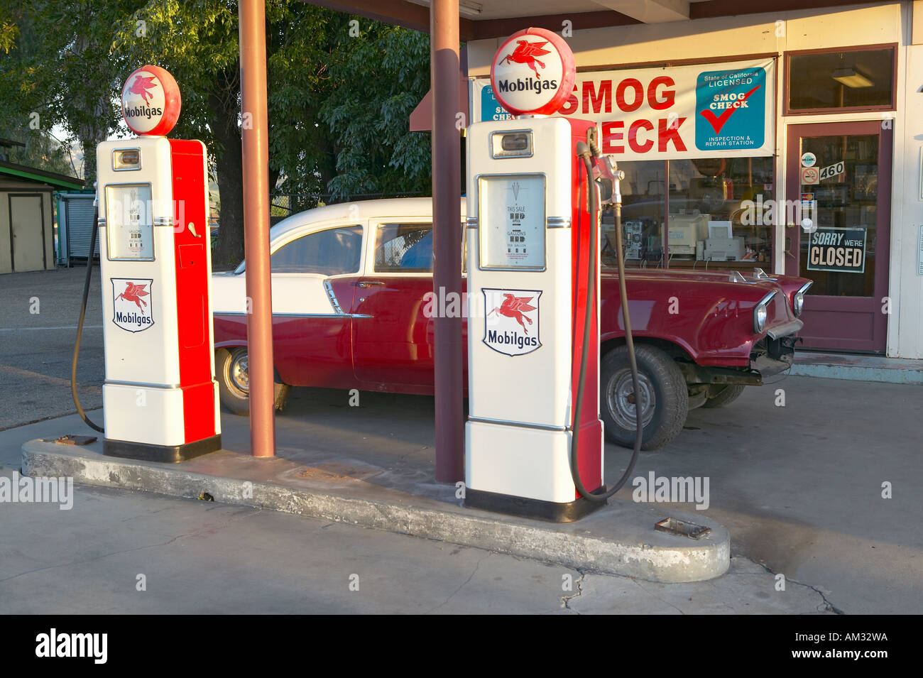 A vintage 1957 Chevy parked in front of antique gas pumps at Ernie s old auto garage in Santa Paula CA Stock Photo