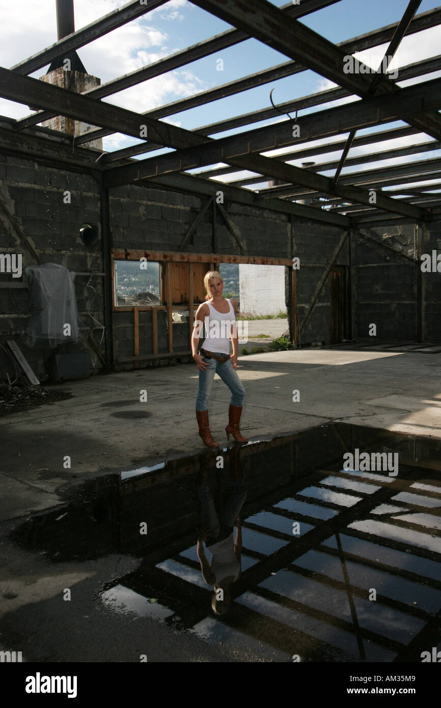 girl standing inside an old rubble building Stock Photo
