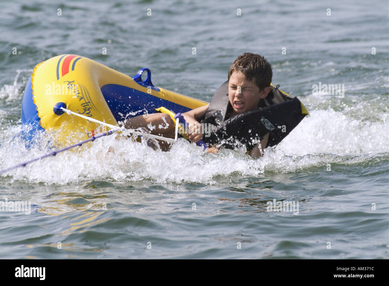 France landes biscarrosse pond young boy riding an inflatable boat ...