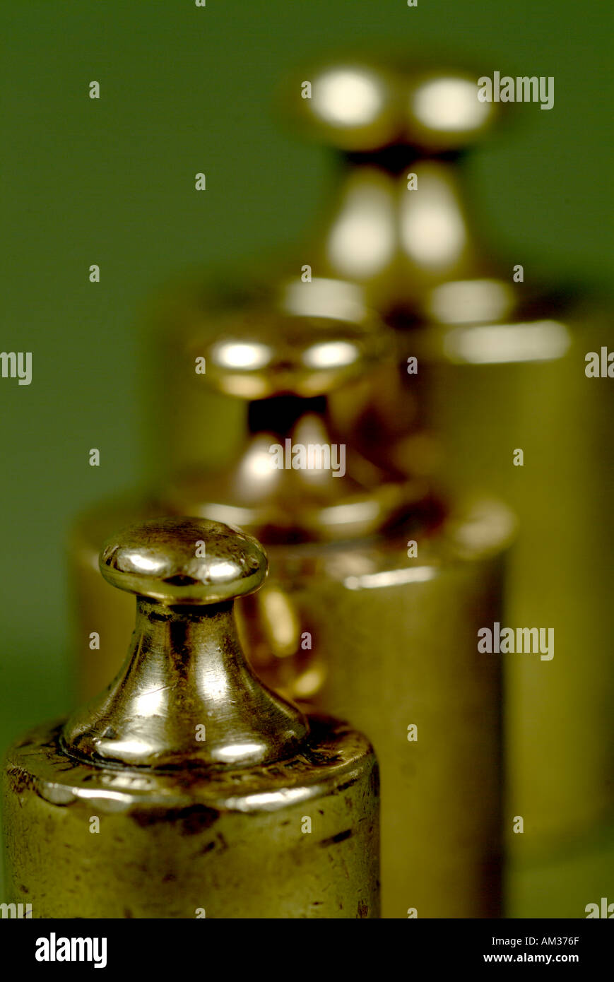 Three french copper scale weights aligned Stock Photo - Alamy