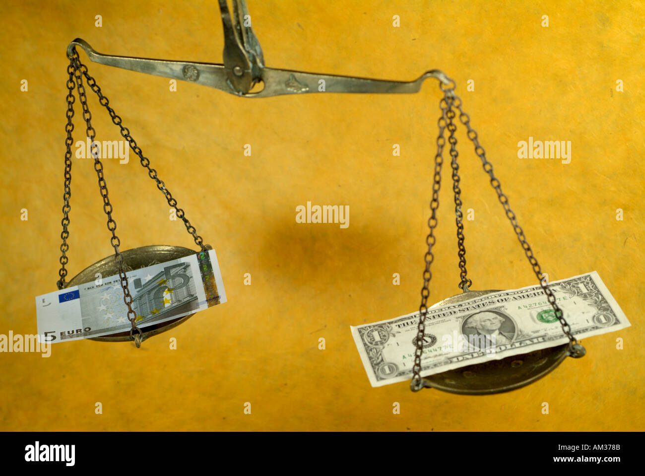 Scale weighing a five euro banknote and a one dollar banknote Stock ...