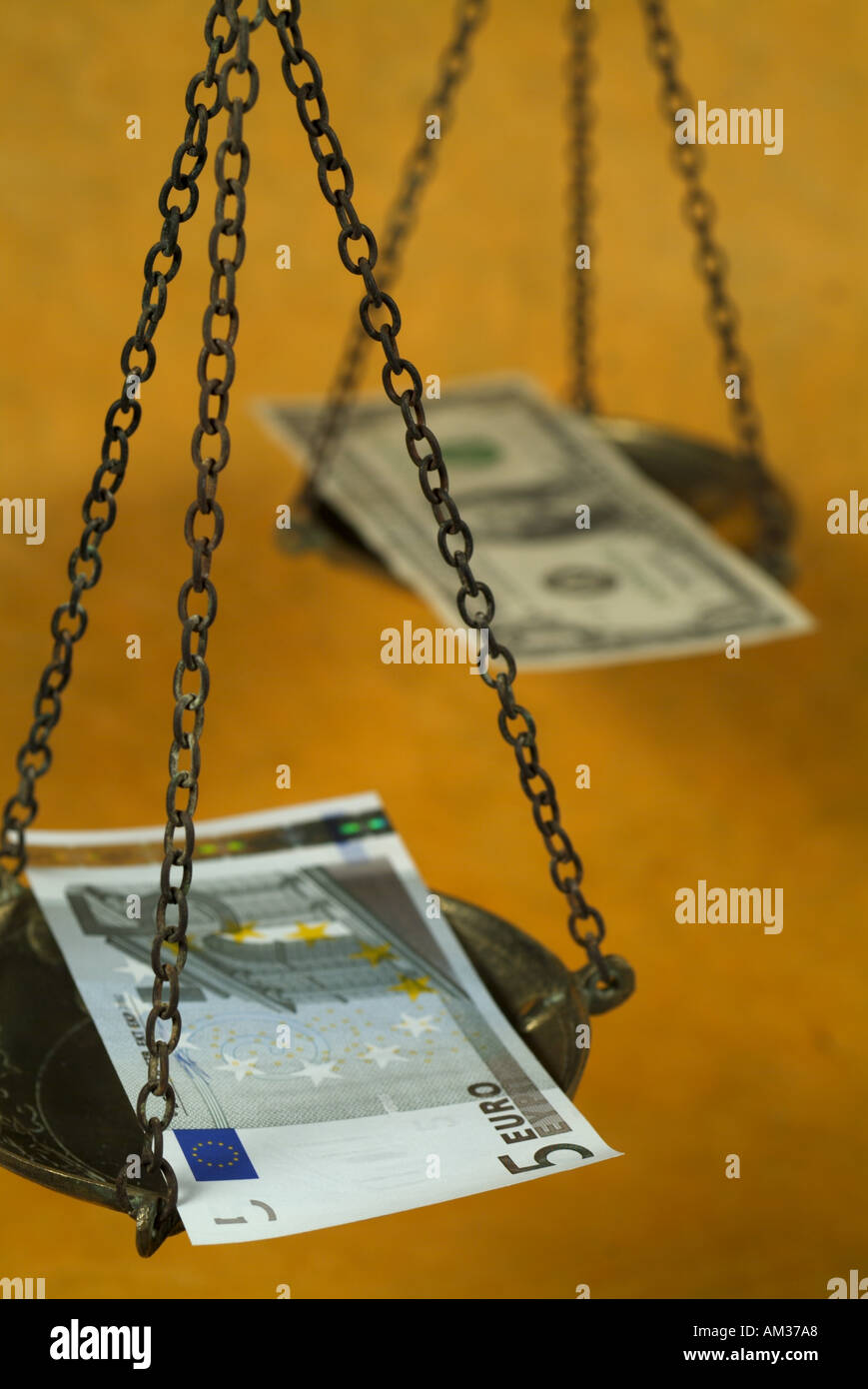 Scale weighing a five euro banknote and a one dollar banknote Stock ...