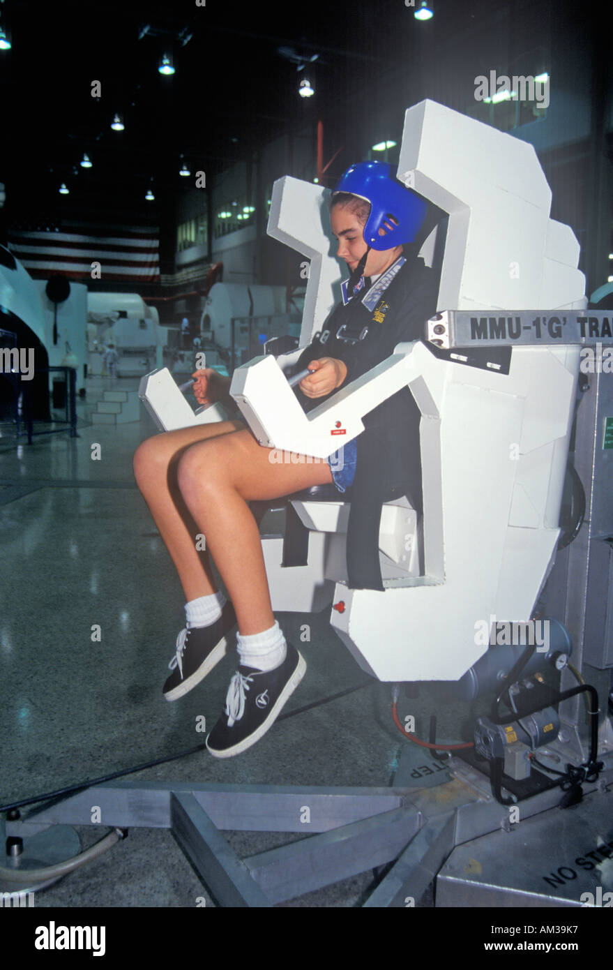A girl attending space camp at the George C Marshall Space Flight Center in Huntsville Alabama tries a MMU 1 G Trainer Stock Photo