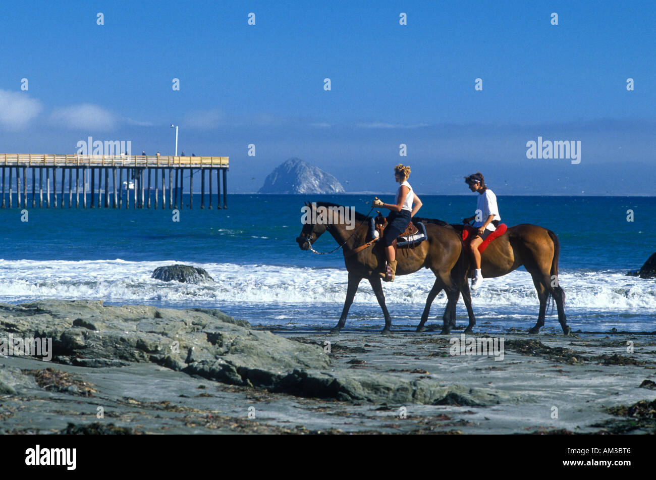 Girls riding horseback on beach Morro Bay CA Stock Photo Alamy