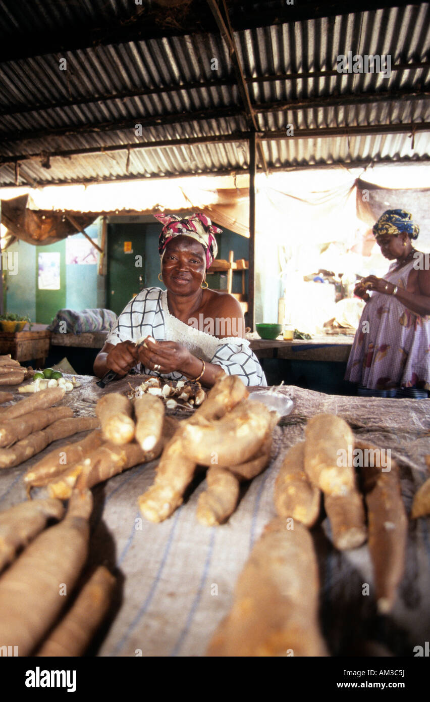 west africa gambia banjul a woman selling yams in the market Stock