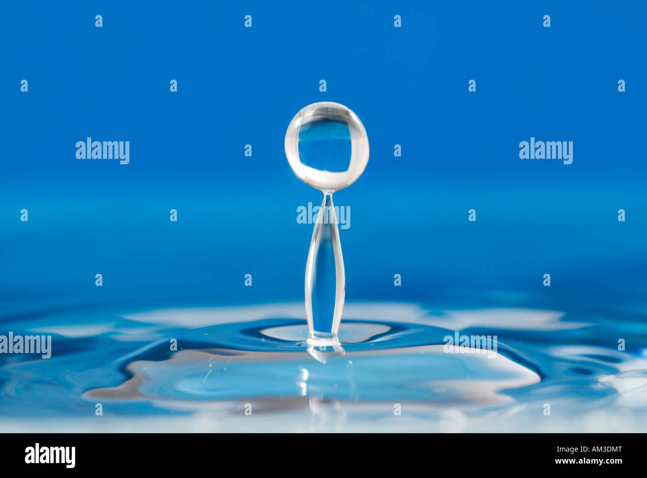 Blue water with jumping waterdrop Stock Photo