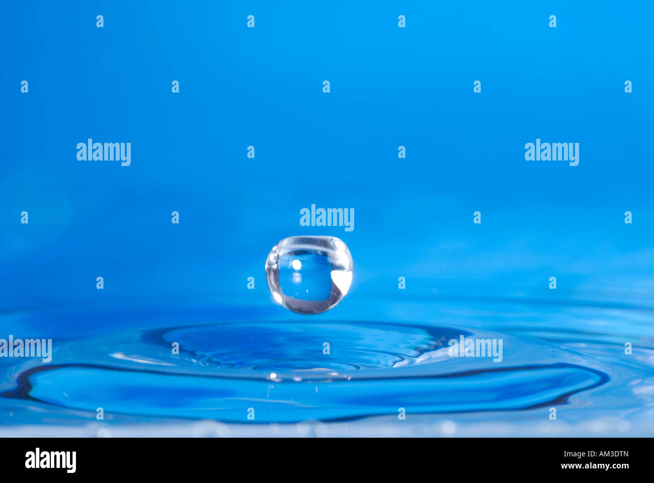 Blue water with jumping waterdrop Stock Photo