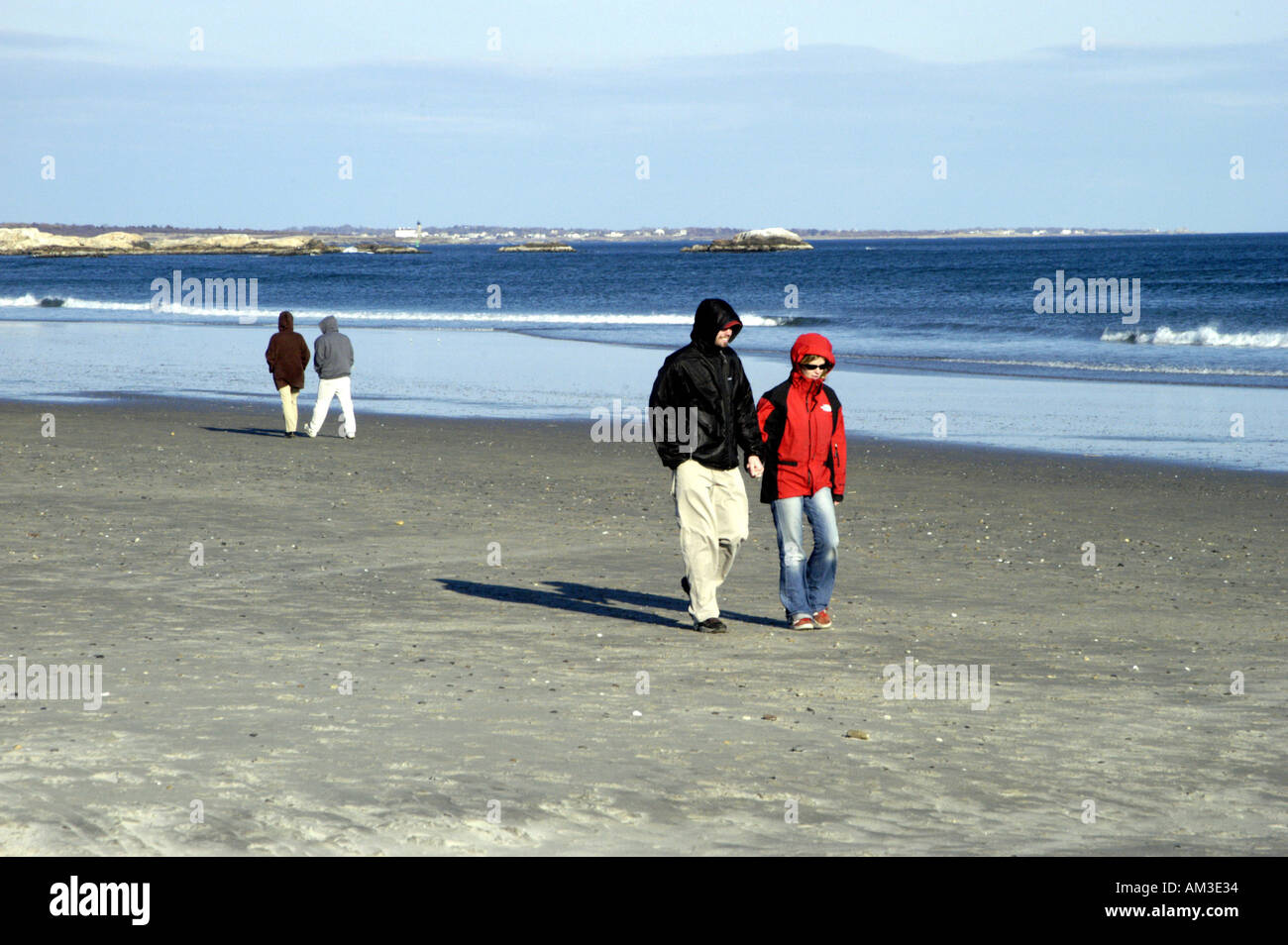 Two couples walking on beach in winter Stock Photo