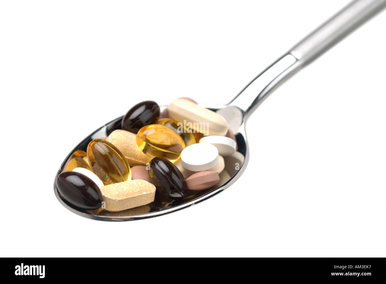 Spoonful of vitamins and food supplements Stock Photo