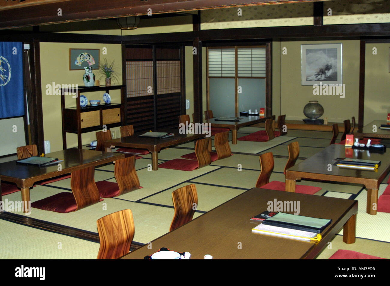 Traditional old style Japanese restaurant with tatami mat flooring and  floor level seats and cushions in Osaka Japan Stock Photo - Alamy
