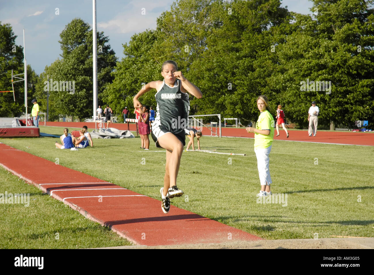 Teenage girl in the triple jump event of a high school track and field