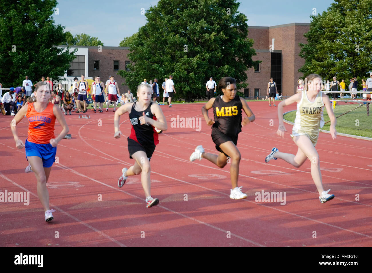 Teenage girl runners at a high school track and field district meet