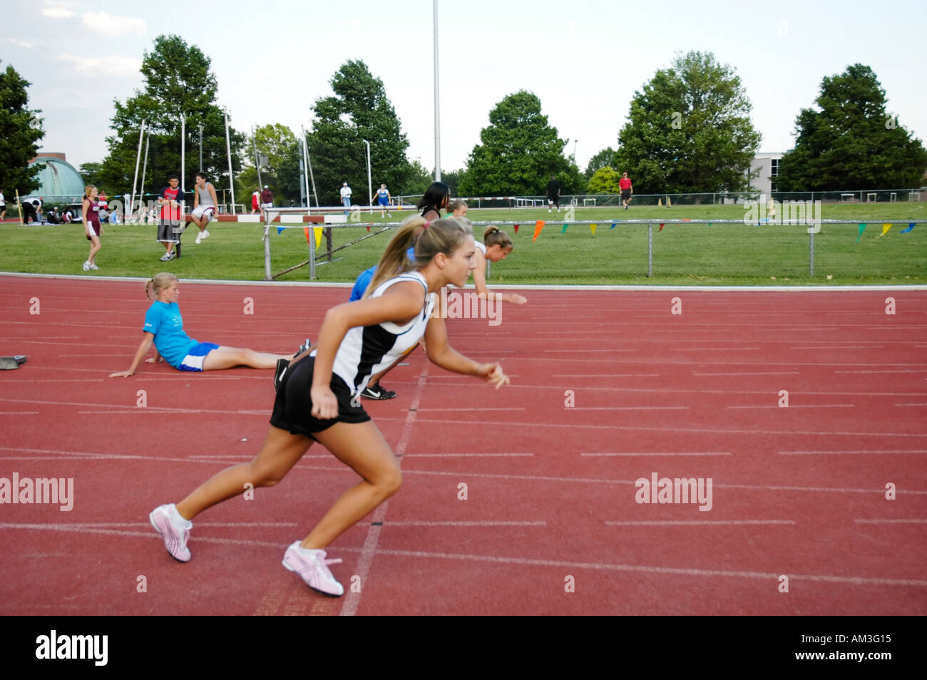 Teenage girl runners at the starting line of a high school track and