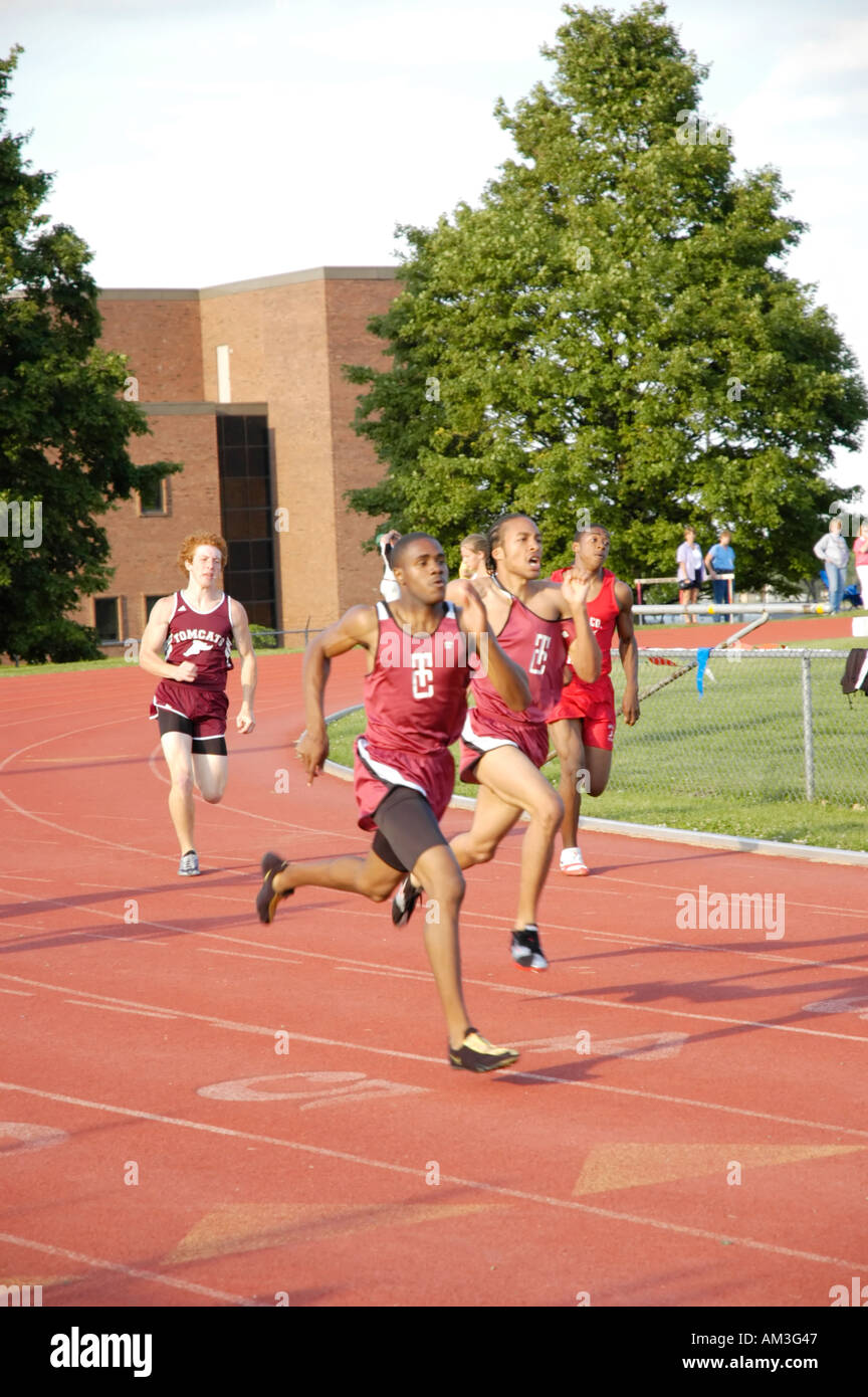 Teenage boy runners at a high school track and field district meet