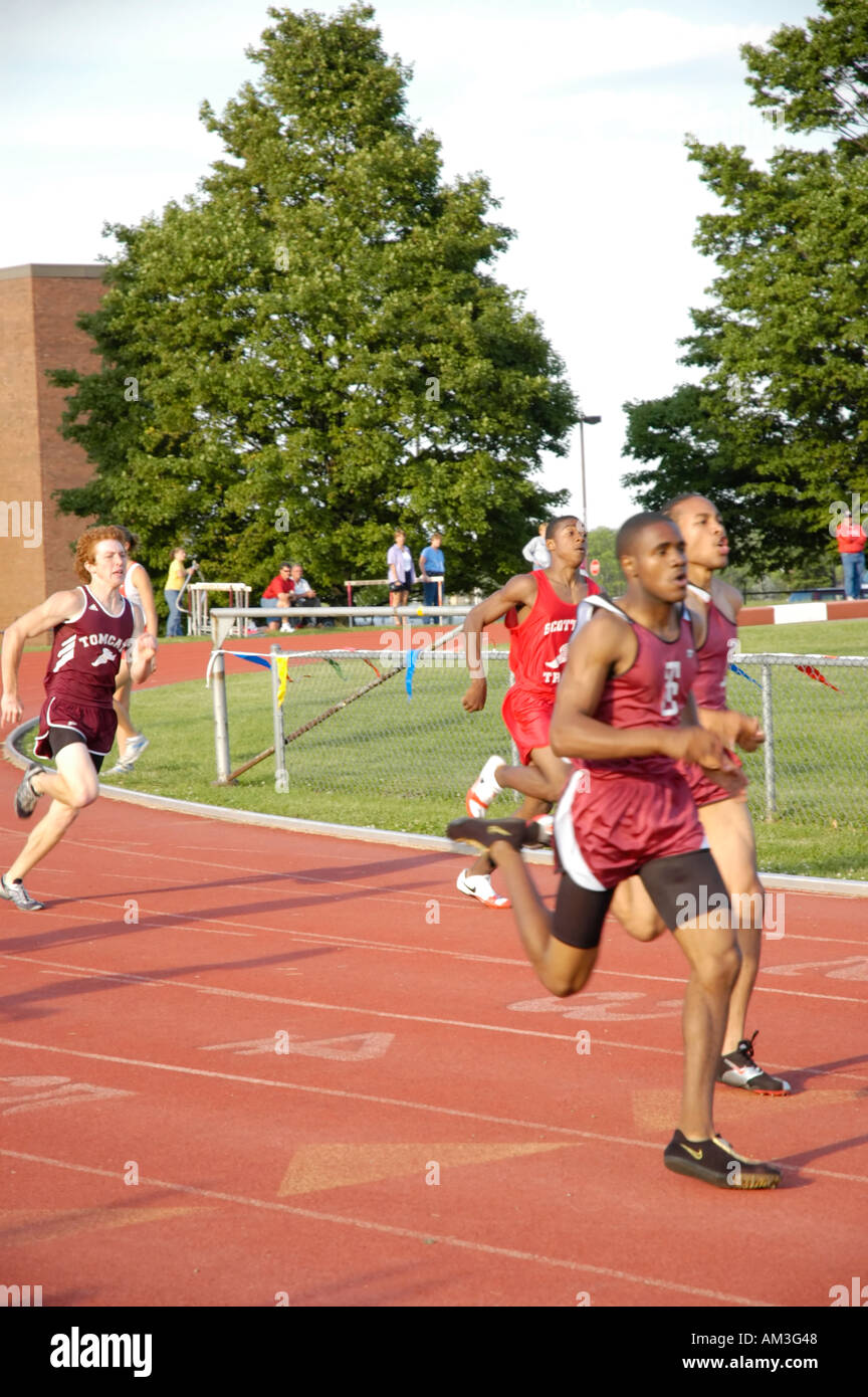 Teenage boy runners at a high school track and field district meet