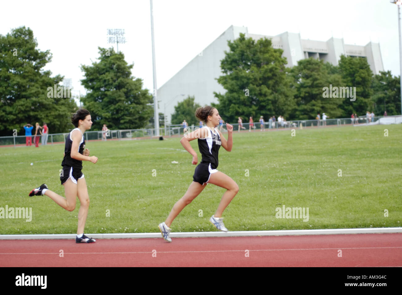 Teenage girl runners at a high school track and field district meet