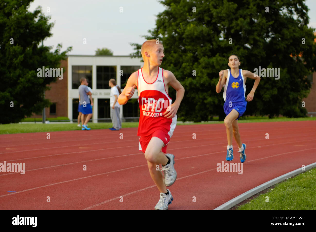 Teenage boy runners at a high school track and field district meet with