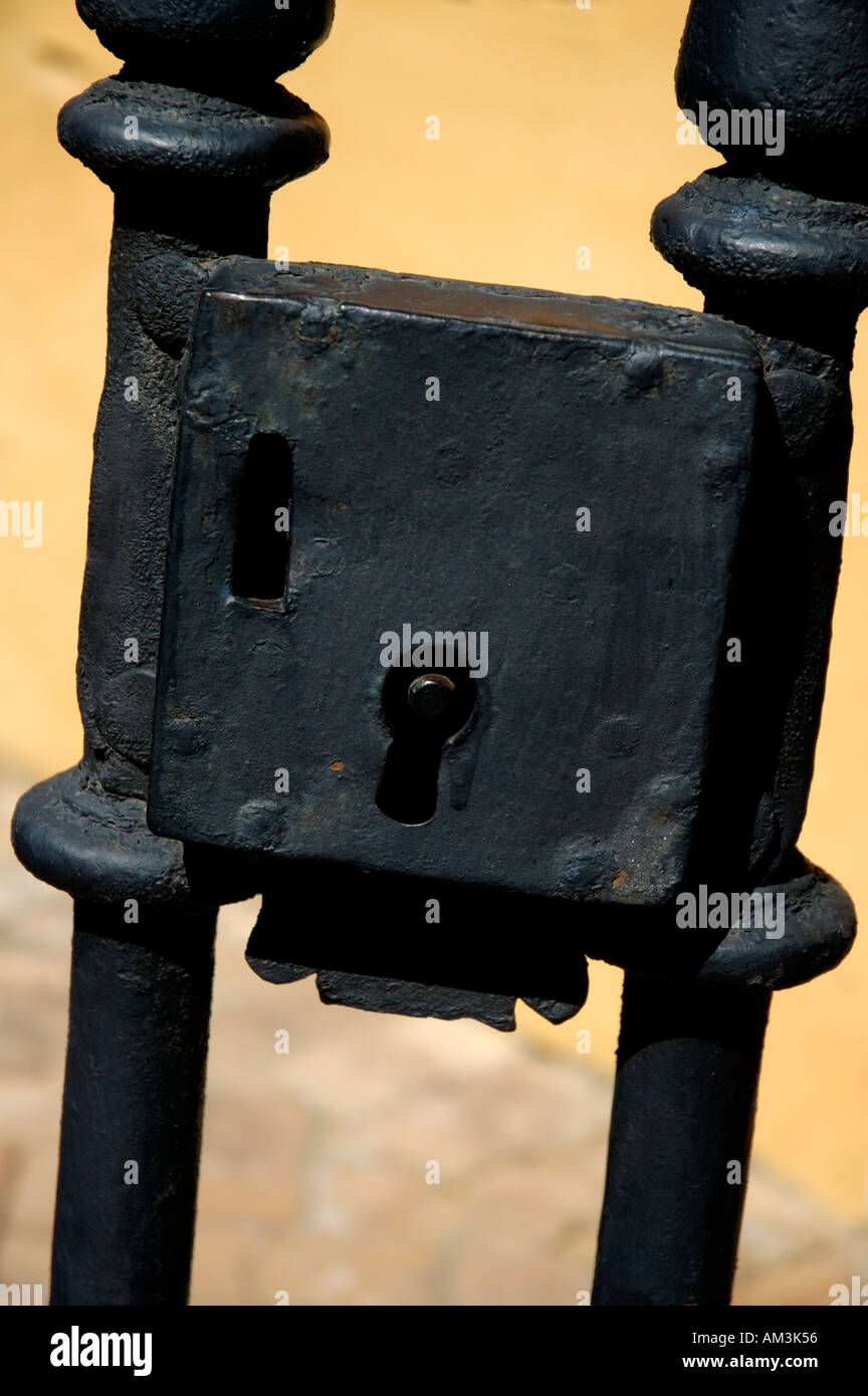 Large lock on a wrought iron gate in the grounds of the Alcazar of Seville, Seville, Andalusia, Spain. Stock Photo