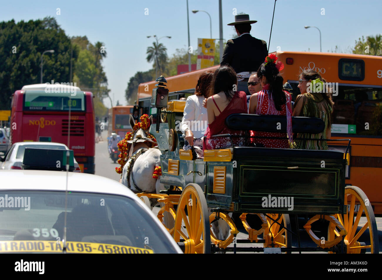 Coachman driving a family in a barouche carriage during the Seville