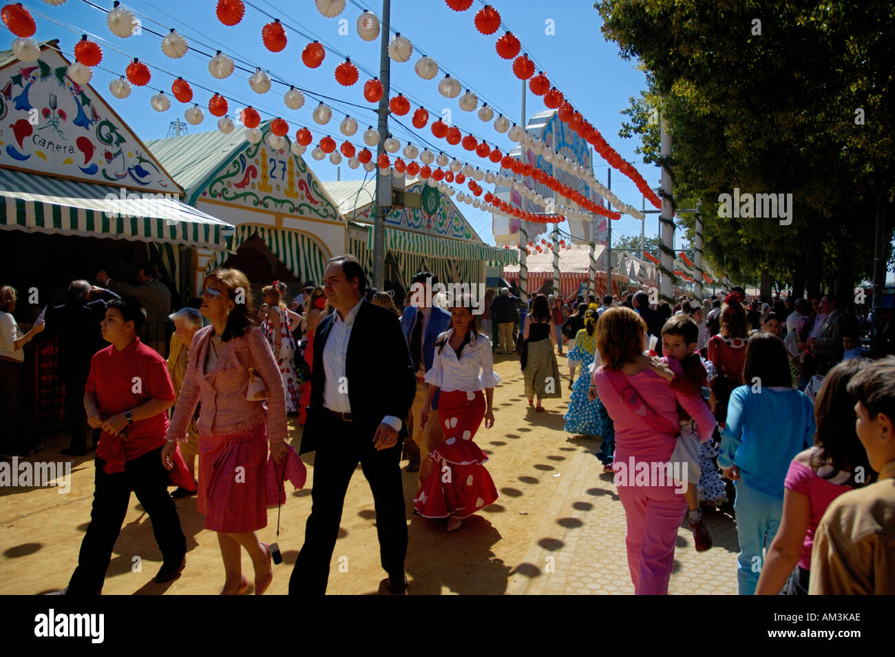 Women in flamenco dress during the Seville Spring Fair in the Los Remedios district, Seville, Andalucia, Spain. Stock Photo