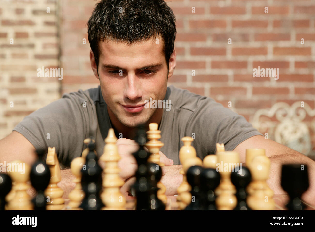 A young chess player contemplates a game plan or strategic