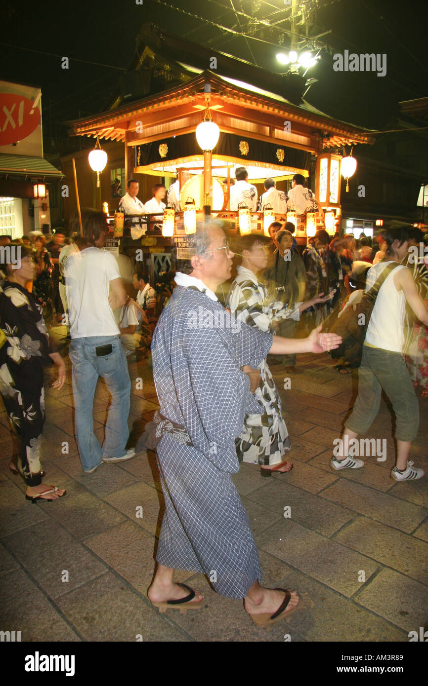 Man in yukata (summer cotton kimono) dances at a summer obon festival in Japan Stock Photo