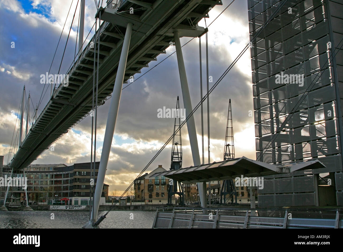 The Royal Victoria Dock Bridge is a signature high-level footbridge crossing the Royal Victoria Dock Docklands london england Stock Photo