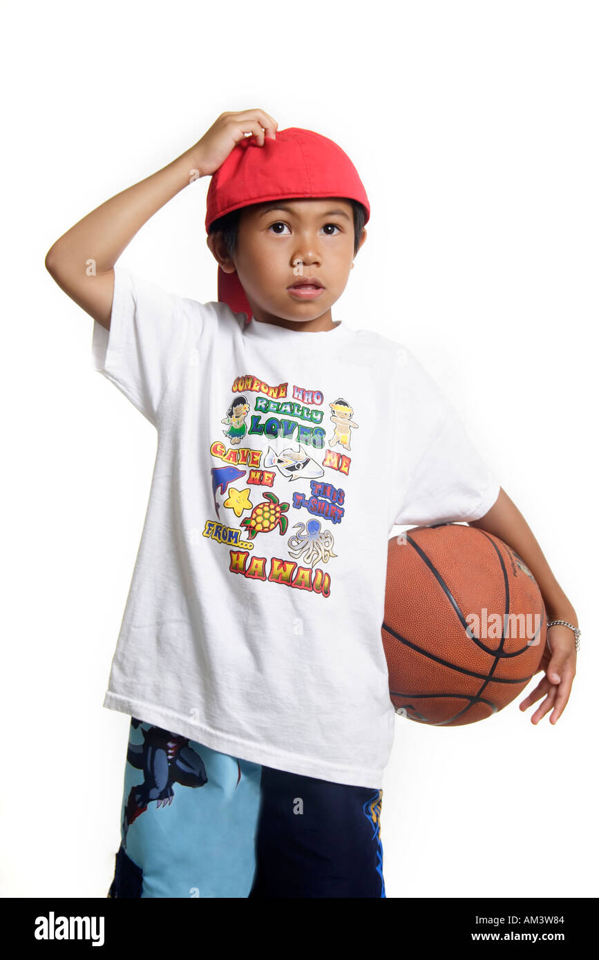 Little boy scratching his head holding a basketball Stock Photo Alamy