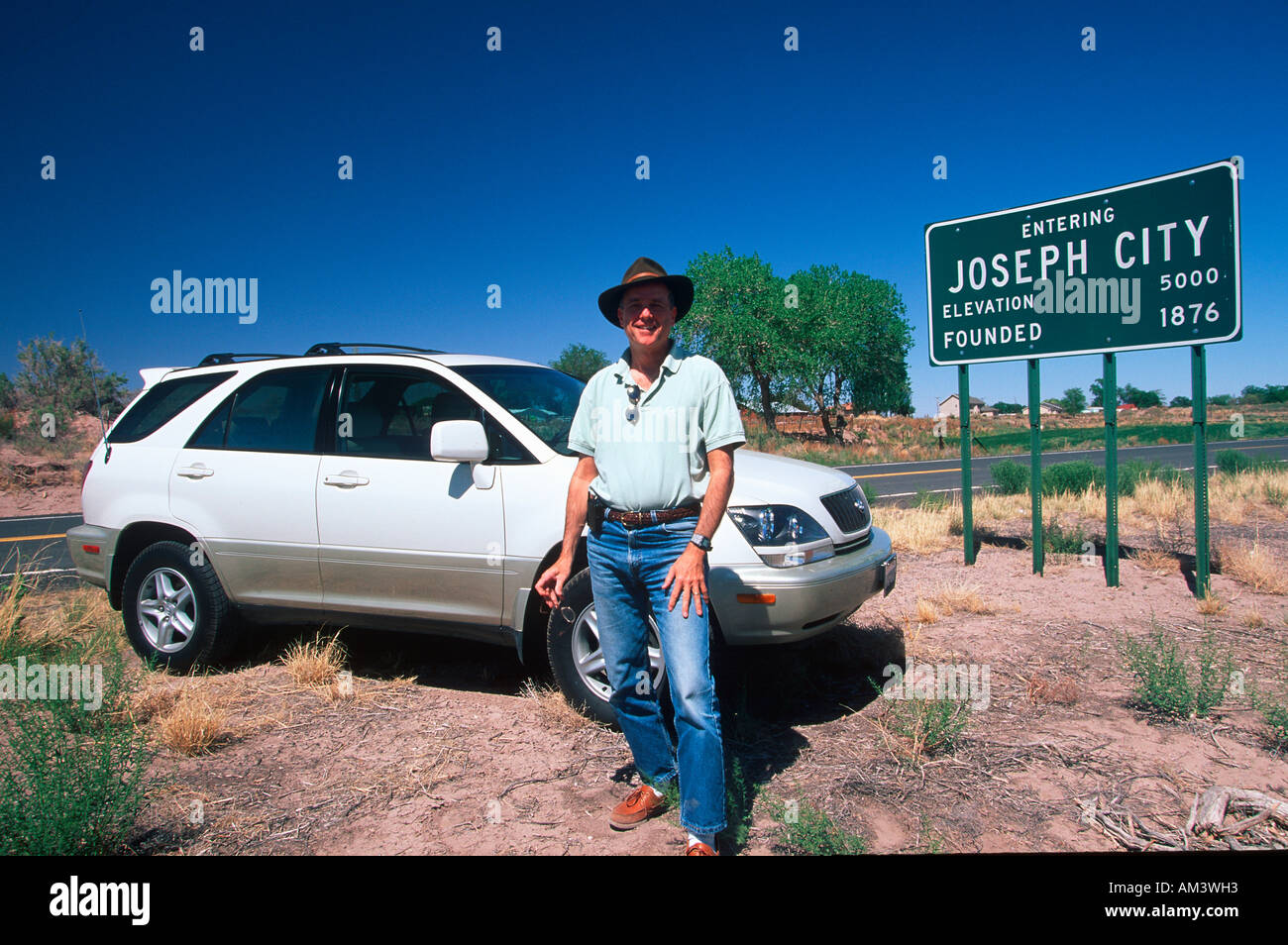 Joe Sohm in front of city sign of Joseph representing Joseph Sohm in western states Stock Photo
