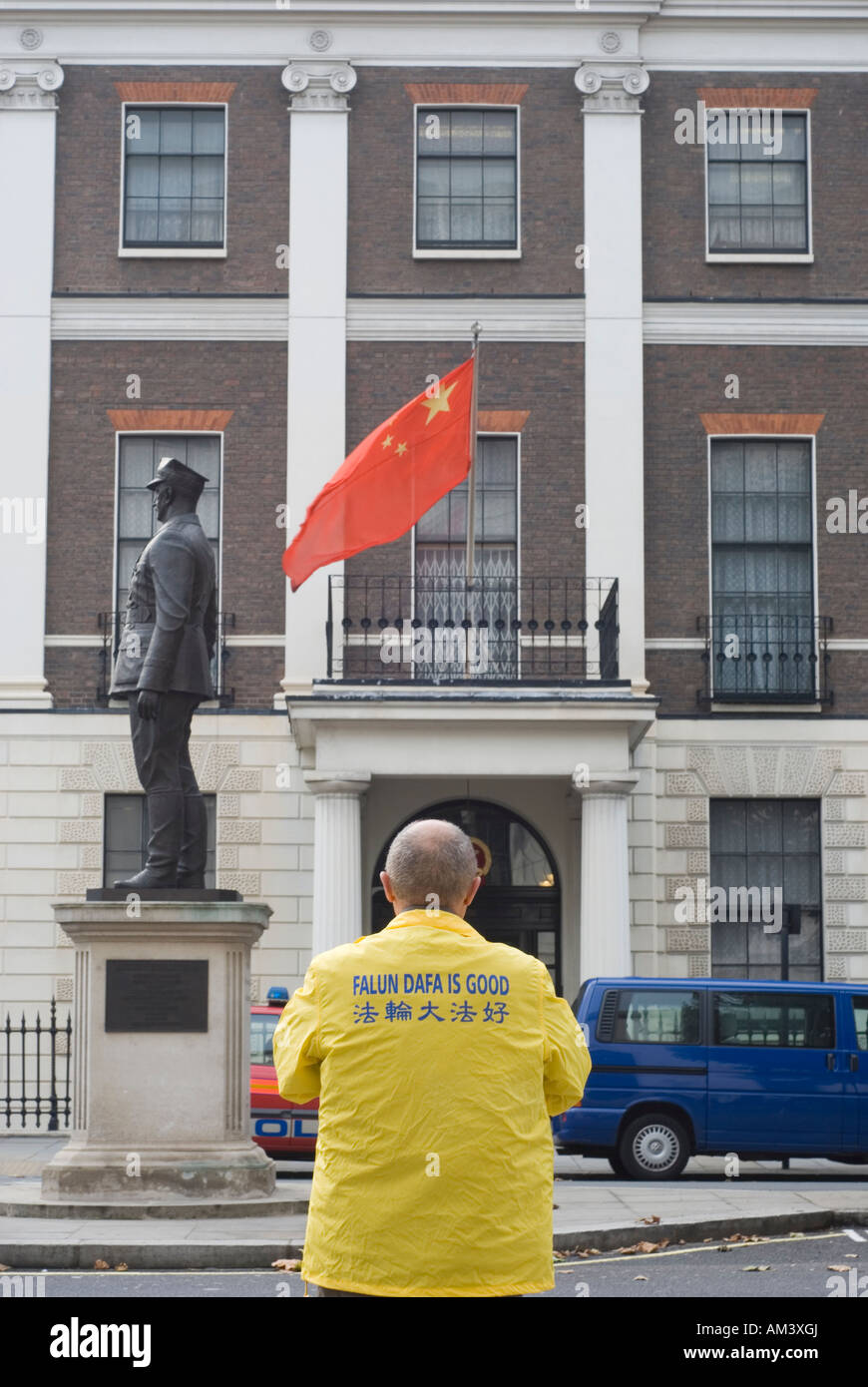 Falun Dafa is Good caption on back of lonely demonstrator outside Chinese embassy in London Stock Photo