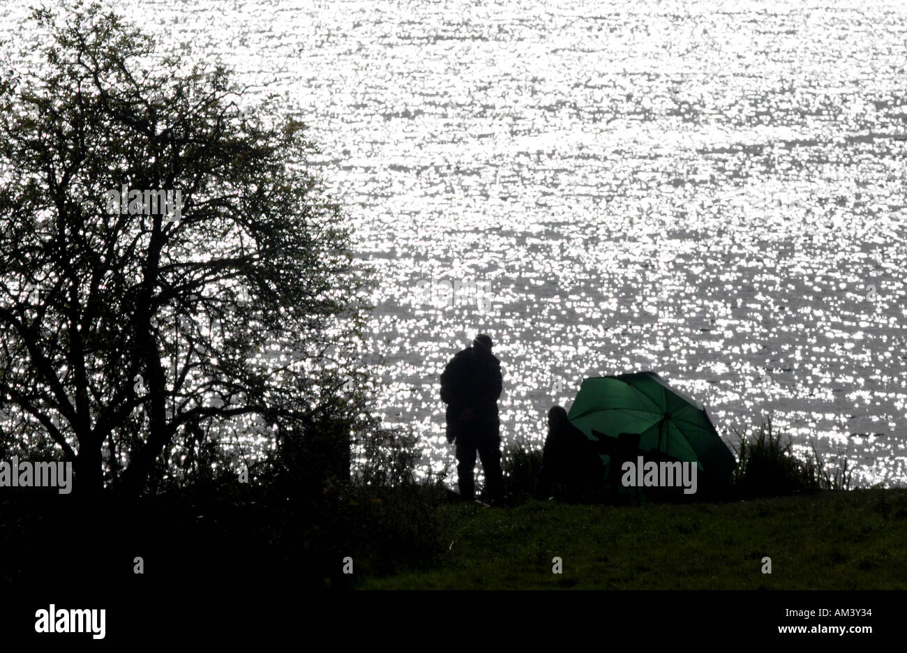 Silhouette of fishermen Stock Photo - Alamy