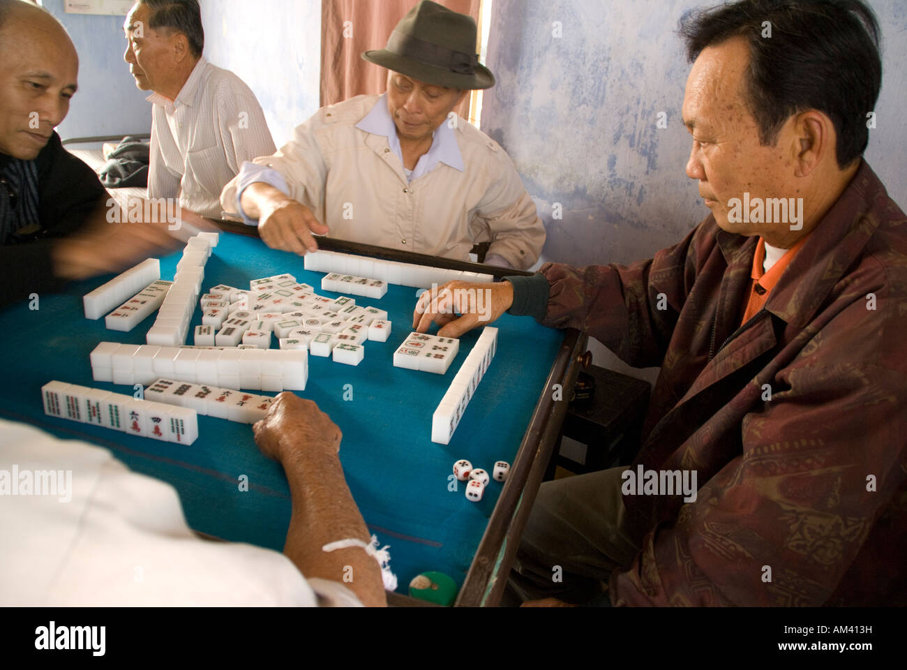 Elderly Vietnamese men playing game of mah jong in Old Town of Hoi An Stock Photo