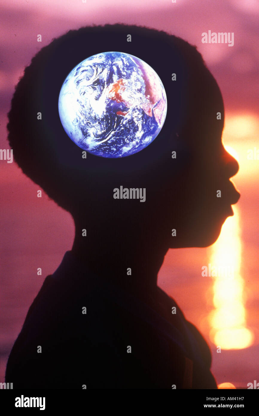 Silhouette of a child with the Earth superimposed over his head Stock Photo
