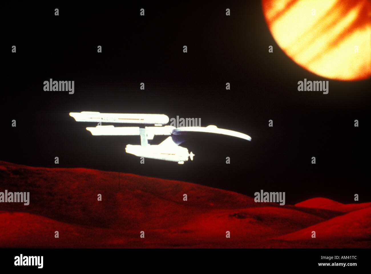 Star Trek s USS Enterprise soars over and alien landscape Stock Photo