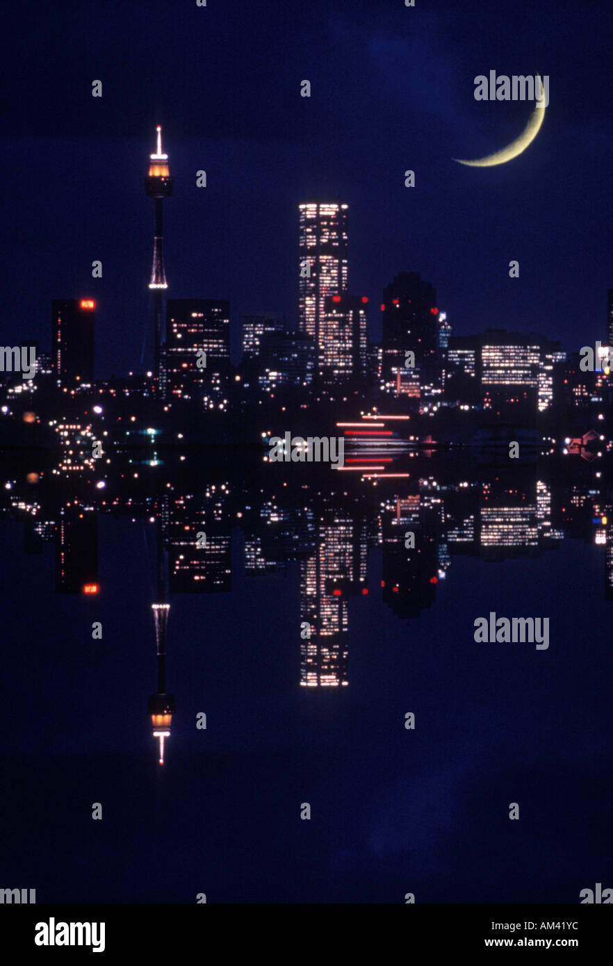 Nighttime cityscape and crescent moon composite Stock Photo