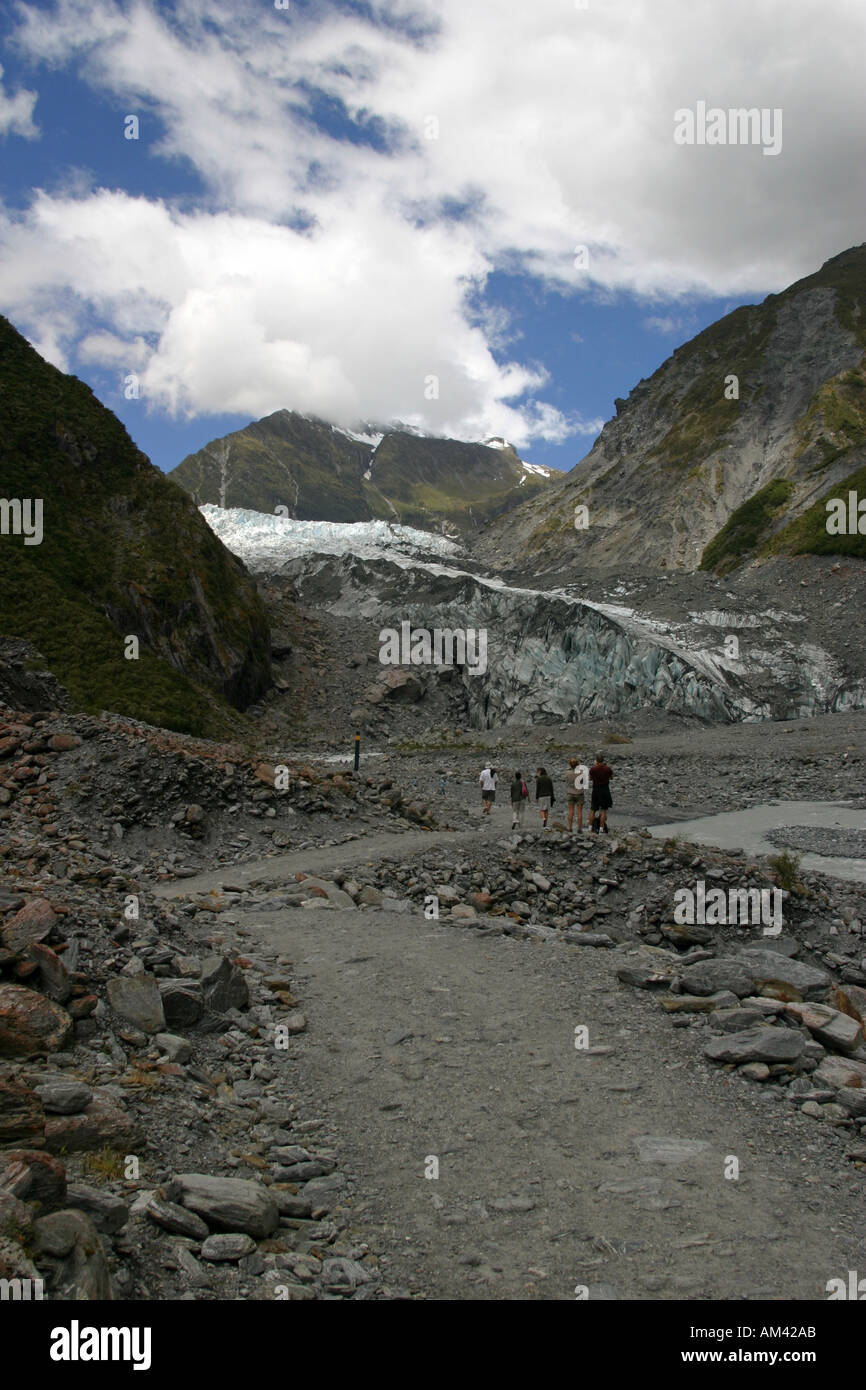 Tourists stop on the path to view the Fox Glacier Mt Cook national park South Island New Zealand Stock Photo