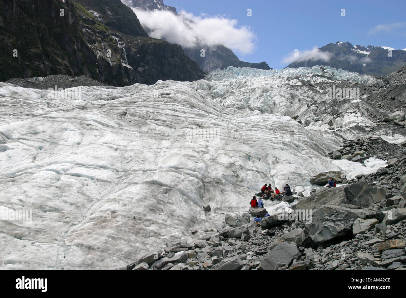 An organised guided tour group stops for lunch on the Fox Glacier in the Mt Cook National Park South Island New Zealand Stock Photo