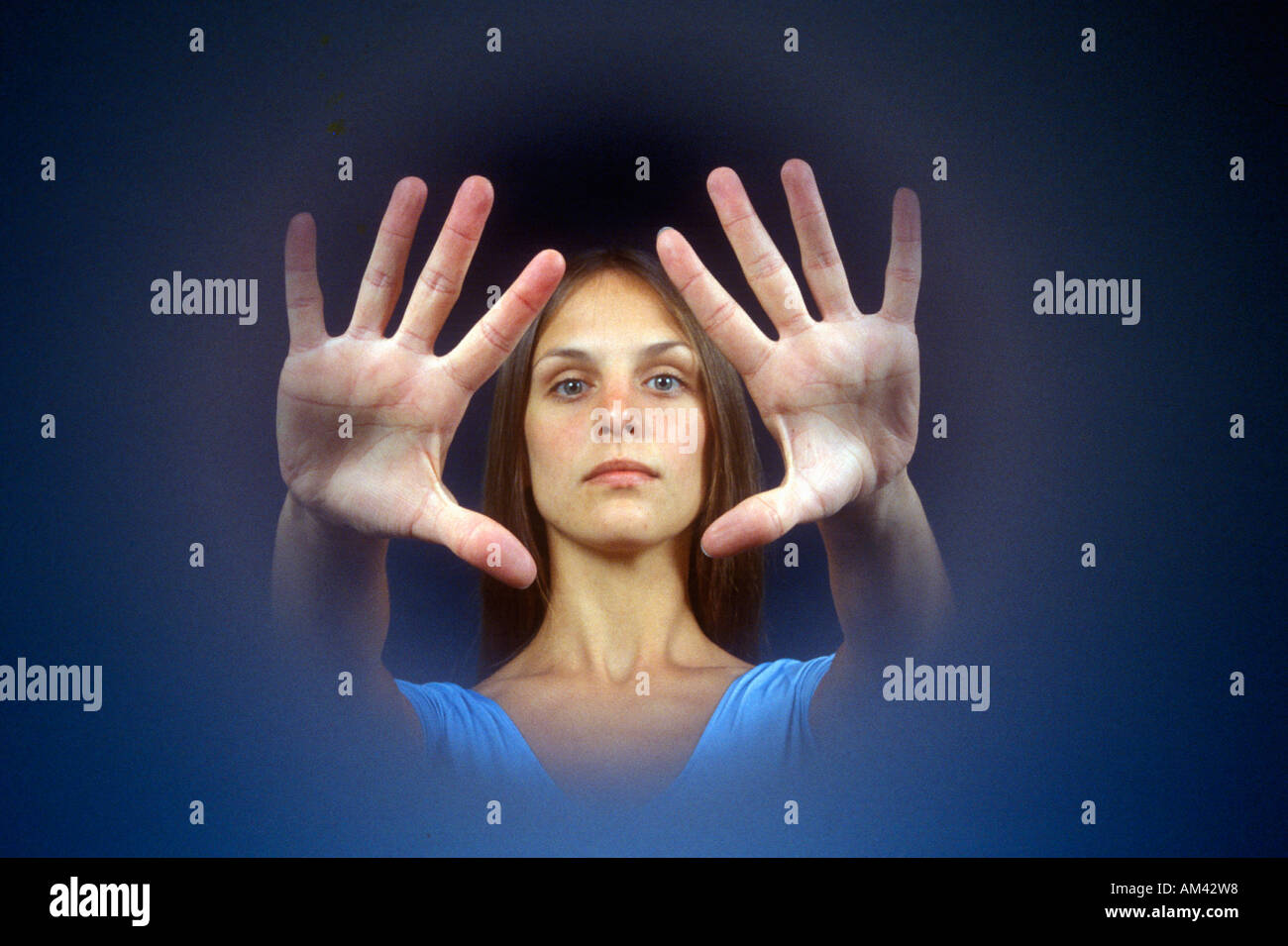 Vignette of a woman s head and hands held out before her Stock Photo